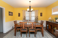 Yellow and white dining room with a grey rug.